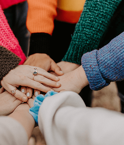 A group collectively putting their hands together