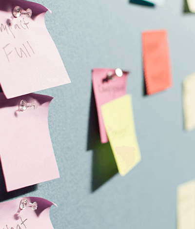 Multicolor post-it notes pinned to a board