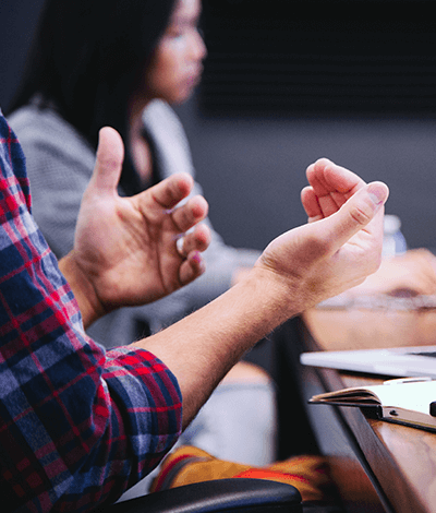 A photo focused on someone's hands while they're explaining something